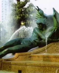 Swann Memorial Fountain with a winged reclining bronze figure spraying water from the multi-tiered basin.