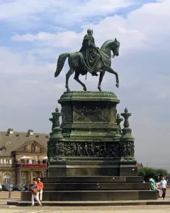 King Johann Memorial bronze equestrian statue on an ornate pedestal in a public square.
