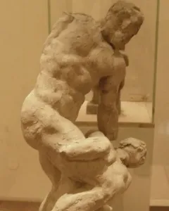 Michelangelo\'s Two Wrestlers, an earthen-toned sculpture of two muscular male figures locked in a wrestling struggle.