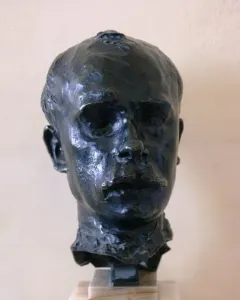 Bronze bust of Octave Mirbeau on a light marble base