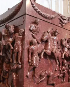 Red porphyry Sarcophagus of Helena carved with mounted soldiers, figures, and garland decoration.