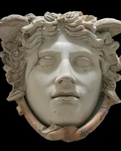 Medusa Rondanini marble head with closed eyes, wavy hair, and snake-like forms around the lower face.