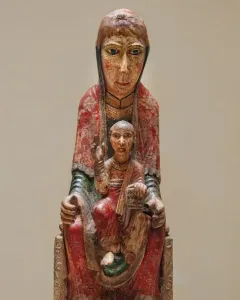 Virgin from Ger, a painted wooden Madonna and Child sculpture with faded red and yellow pigments.