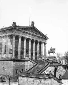 Frederick William IV equestrian statue in front of a classical building with columns and a sculpted frieze.