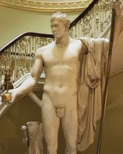 Napoleon as Mars the Peacemaker statue on a dark pedestal, showing a white marble nude figure holding a golden orb and staff.