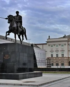 Prince Józef Poniatowski Monument, a dark equestrian statue on a tall stone pedestal in a paved square.