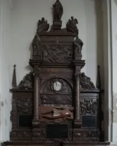 Tomb of Lew Sapieha with a central armored reclining figure and smaller draped figures in a multi-tiered stone monument