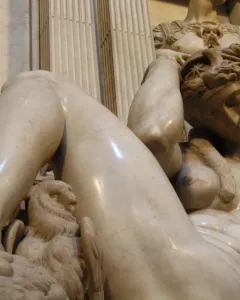 Michelangelo’s Night, a reclining nude marble figure with an owl and mask on the base.
