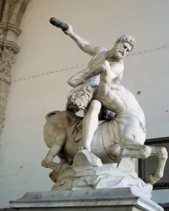 Heracles and Nessus marble sculpture showing a muscular man wrestling a centaur with a club raised overhead