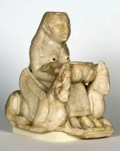 Lady of Galera seated stone figurine holding a bowl, flanked by winged creatures