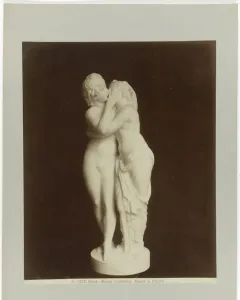 Cupid and Psyche marble sculpture showing two youthful figures embracing and kissing.