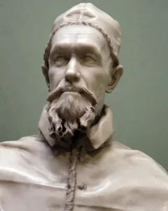 Marble bust of Pope Innocent X with a curly beard, mustache, and clerical cap.