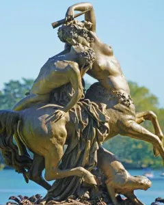 Centauress and Faun sculpture showing a female centaur rearing while kissing a man on her back.