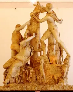 The Farnese Bull marble sculpture showing a dramatic scene with two men struggling to subdue a bull and a female figure beneath it.