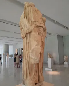 Procne and Itys marble sculpture in a museum gallery, with draped folds and missing upper sections.