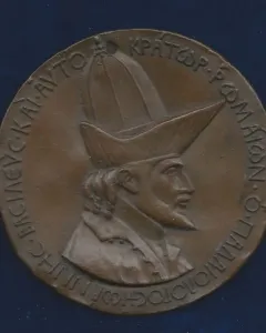 Bronze-toned medal of John VIII Palaiologos showing a bearded bust in right profile with a Greek inscription around the edge.