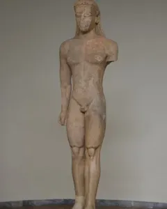 Sounion Kouros marble statue of a nude male youth with long braided hair, shown front-facing with a missing left arm.