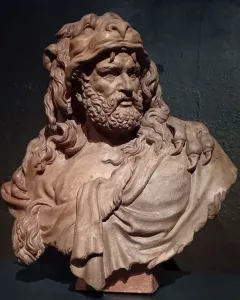 Clay bust of Hercules with a fur pelt draped over his shoulders and a bearded, determined face.