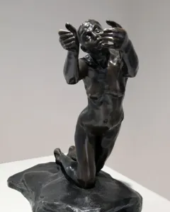 The Implorer bronze sculpture of a kneeling nude woman with raised hands and an upward gaze.