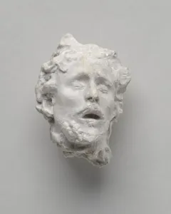 Head of Saint John the Baptist sculpture with closed eyes and an open mouth, shown in a weathered white surface.