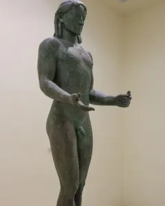 Piraeus Apollo bronze statue of a nude male figure with long hair and outstretched arms