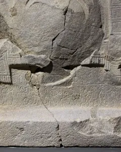 Çineköy inscription on a fractured stone block with carved ancient characters and relief designs.