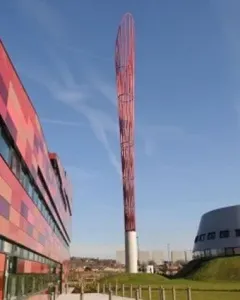 Aspire sculpture rising above the University of Nottingham Innovation Park, with modern buildings on either side.