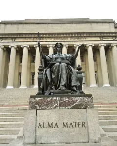 Alma Mater, a bronze seated female figure holding an open book and scepter on a stone pedestal outside Columbia University.