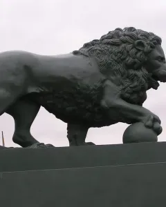 Lions at the Dvortsovaya Pier sculpture of a standing lion with a paw on a sphere.