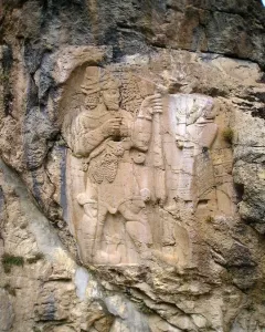 Ivriz relief showing two carved figures, one holding a staff and grapes.