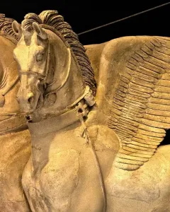 Detail of the Winged Horses of Tarquinia showing two winged horse heads and upper bodies in relief.