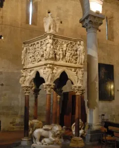 Sant\' Andrea Pulpit with carved figures and stone columns inside a church interior