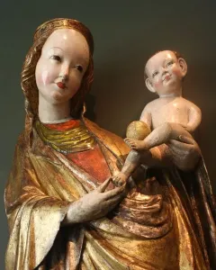 Beautiful Virgin Mary from Krużlowa, a crowned Madonna sculpture in golden robes holding a naked infant and a golden orb.