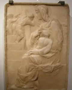 Madonna of the Stair relief showing a seated woman holding a child on her lap beside climbing figures in the background.