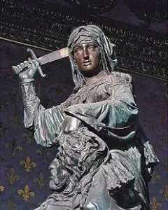 Donatello’s Judith and Holofernes bronze sculpture, showing a woman holding a sword above a bearded male figure.