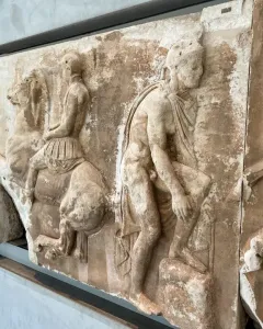 Parthenon frieze marble relief with horsemen and a draped figure