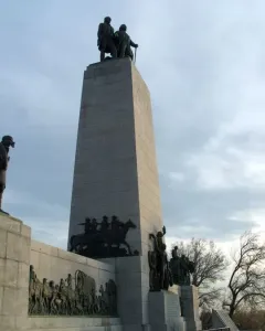 This Is the Place Monument with bronze pioneer statues on top and covered wagon sculptures around the base.