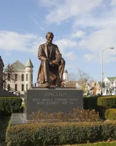 Seated bronze Abraham Lincoln statue on a granite pedestal inscribed with Lincoln\'s quote.