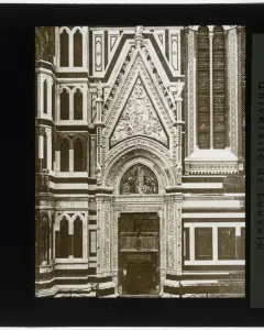 Porta della Mandorla portal on the facade of Florence Cathedral, with a carved arched doorway and ornate reliefs above it.