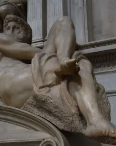 Michelangelo\'s Day, a reclining nude marble male figure in the Sagrestia Nuova.