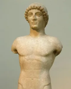 Apollo Strangford marble kouros statue with missing arms and lower legs, shown frontally on a dark base.