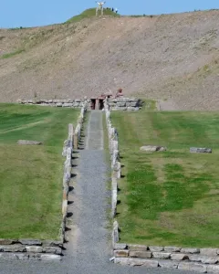 Stone rows lead along a gravel path toward the Omphalos on a hillside at Crawick Multiverse.