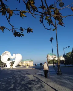 Peace Dove sculpture with smooth white abstract curves in a park