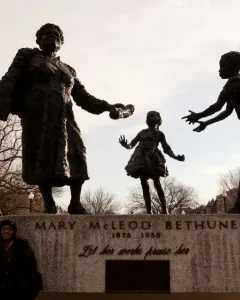 Mary McLeod Bethune Memorial bronze statue of Mary McLeod Bethune with two children reaching toward her.