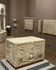 Baptistry of Callistus, an octagonal stone baptismal font with slender columns, arches, and carved decorative patterns.