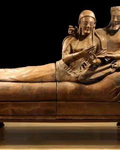 Sarcophagus of the Spouses showing a smiling man and woman reclining together on a banqueting couch.