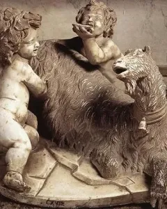 The Goat Amalthea marble sculpture showing a shaggy goat with two small child-like figures beside it.