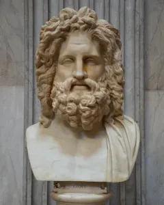 Zeus of Otricoli marble bust with curly hair and a beard on an inscribed pedestal.