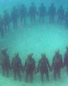 The Molinere Underwater Sculpture Park’s ring of human-like figures standing hand in hand on the seabed.