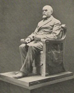 Timothy Eaton statue showing a seated bearded man in a double-breasted suit on a rectangular base.